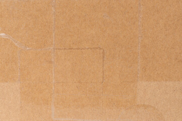 Fototapeta premium Brown cardboard box with different patches and textures in well-lit environment