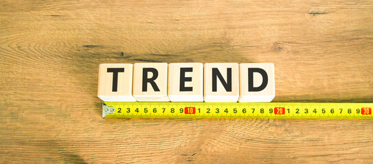 Trend and trending symbol. Concept word Trend on beautiful wooden blocks. Beautiful wooden table wooden background. Beautiful yellow ruler. Business lifestyle trend and trending concept. Copy space.