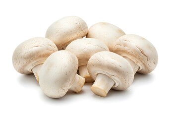 A group of seven white button mushrooms clustered together on a plain white surface in a close up shot