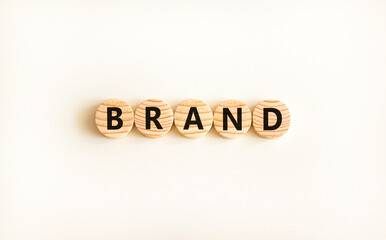 Brand symbol. Concept word Brand on beautiful wooden circles. Beautiful white table white...