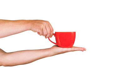 Close-up. Isolated red mug for coffee, tea in the hands of a man. On a white background.