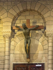 Principality of Monaco, France - July 9, 2024: Cathedral of Our Immaculate Lady. Jesus on the cross seems strong and ready to jump.