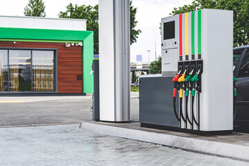 Gas station hoses with gasoline and diesel fuel. against the backdrop of the window.