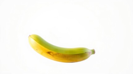 Single Banana on White Background Showing Half Green and Half Yellow
