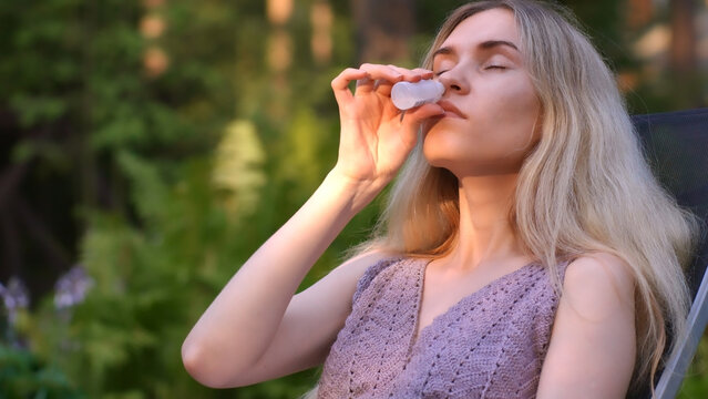 Woman Managing Runny Nose and Allergies Effectively With Vasoconstrictor Drops Outside in the Park