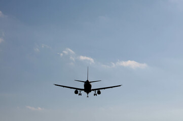 Plane landing, backlit in the sky at a beautiful sunset. A large, beautiful plane. A beautiful image of the sky and the plane landing.