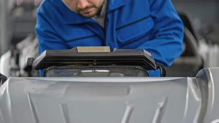A medium closeup shows a service technician performing maintenance on the robotic vehicle underscoring the designs accessibility for repairs and upgrades.