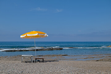 Yellow colored parasols and sunbeds on the beach.