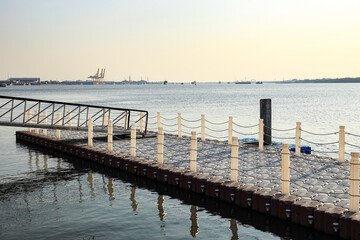 Fototapeta premium Floating Jigsaw or floating plastic pontoon walk way floating in the sea. Plastic Floating Dock. Plastic Pontoon bridge.