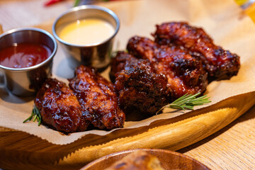 Closeup of chicken wings with dips served at restaurant