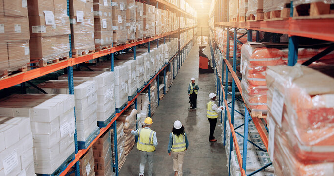Supplier, warehouse and employees walking for logistics, stock inventory or inspection by shelves. Above of industrial people, distribution and supply chain with safety, depot or wholesale storage
