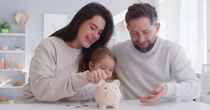 Couple and small baby child putting coin in piggybank happy saving money for new toy, healthcare, managing household budget, planning investment, dreaming of future, enjoy, learning to count at home
