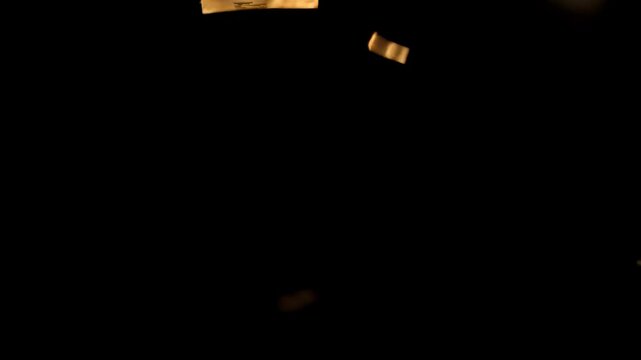 Luxury Gold Confetti Falling Animation: Celebration Video Overlay on Black Background. Ideal for Awards Night Visuals, Glam Party Invites & VFX. 4K video.