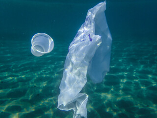 Naklejka premium Bag in underwater, Environmental pollution problem plastic bottle in sea, Plastic rubbish garbage pollution in ocean, Plastic Bag floating underwater in Mediterranean sea, Plastic ocean pollution.