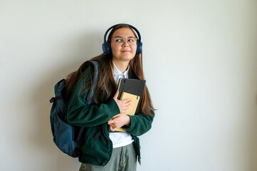 Teenage student holding books on white background