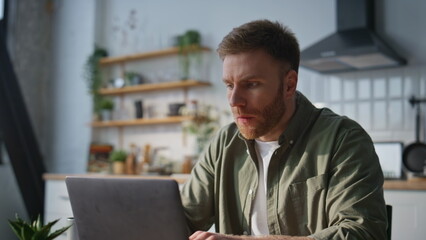 Fototapeta premium Serious businessman typing laptop at home office closeup. Busy manager working