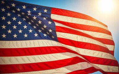 Fototapeta premium American flag waving in the sunlight.