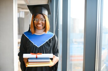 beautiful young afro american graduate holding diploma