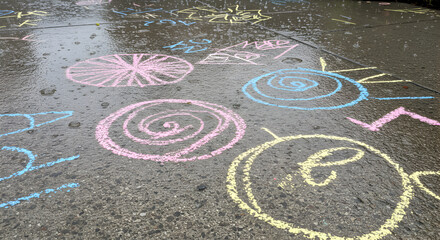 Colorful Chalk Drawings on Wet Sidewalk after a Rainy Day