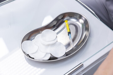 Sterile Stainless Steel Tray Featuring Cotton Pads and A Syringe, Typically Used In Medical And Healthcare Settings For Various Procedures And Treatments