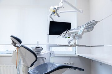 Contemporary Dental Clinic Interior with Advanced Equipment Featuring a Dental Chair and Operatory Area in a Bright and Welcoming Environment for Patients