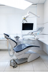 Modern Dental Clinic with Advanced Equipment: A Clean and Bright Dental Chair Ready for Patient Treatment and State-of-the-Art Technology in Dentistry