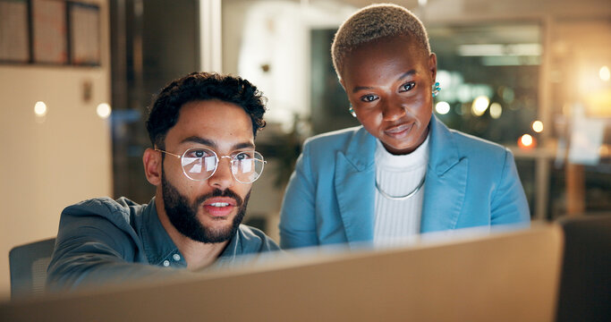 Collaboration, computer and night with employee people in office together for development or planning. Conversation, feedback or review with business man and woman at work for teamwork in evening