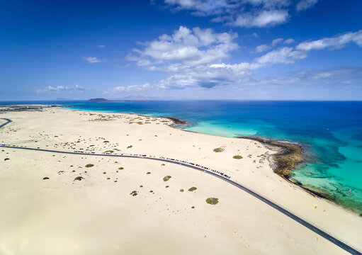 Aerial view of cars parked along a road along Dunas de Corralejo in Parque Natural de Corralejo, Fuerteventura, Canary Islands, Spain