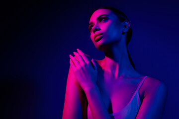 Young woman posing in neon lights with vibrant colors, expressing sensuality and confidence
