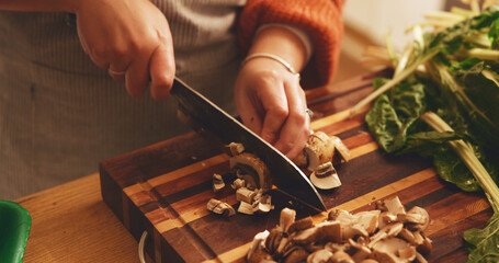 Hands, mushroom and cutting board with cooking in home, meal prep and knife with spinach for...