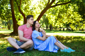 Young Adult Son and Mother Relaxing Together in Park