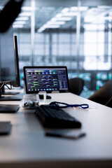 Code running on computer screens and tablet in empty data center workspace used for troubleshooting...