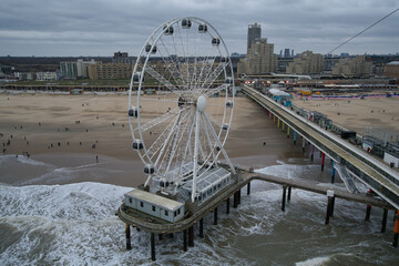big wheel and a jetty at den haag beach