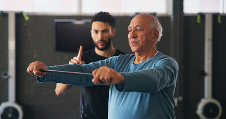 Personal trainer, senior man and resistance band for exercise with workout, guide or support at gym. Coach, help and strong at class for training, stretching or fitness at wellness club in retirement