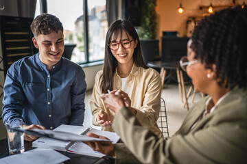 young entrepreneurs sign contract with financial adviser
