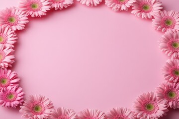 Obraz premium Delicate pink gerbera flowers arranged in a circle frame on a pastel pink background