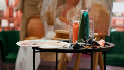Painting inspiration supplies placed and ready to be painted on canvas, watercolor painting technique in modern fine art workshop. Empty creative atelier used in creating innovative artworks.
