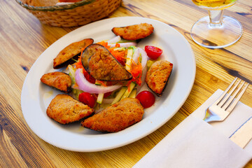 Gratin of mussels served with vegetable salad, French cuisine