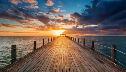 clouds over jetty on sea during sunset