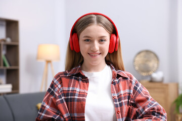 Portrait of smiling teenage girl at home