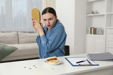 Emotional young woman with slipper looking in disgust at cockroaches indoors. Pest problem