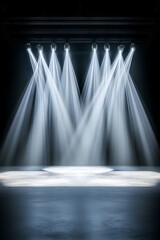 Bright stage spotlights illuminate a dark empty platform