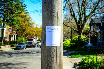 Blank have you seen handbill stapled to a wooden utility pole  out of focus street scene in background room for text	
 room for text
