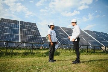 Indian engineer and businessman planing new ecology project. around solar panel