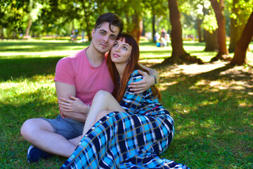Happy Young Couple Relaxing Together in Sunny Park