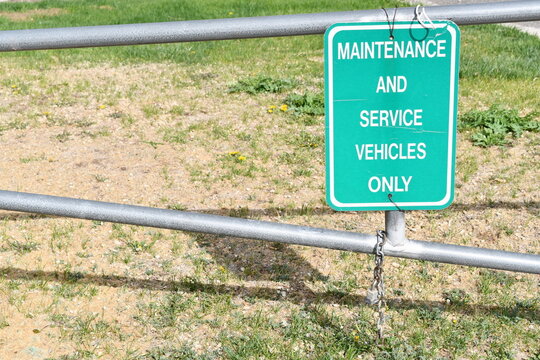 Maintenance and service vehicles only sign on open gate.