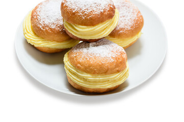 Delicious bakery dreams with creamy filling and powdered sugar on a white plate