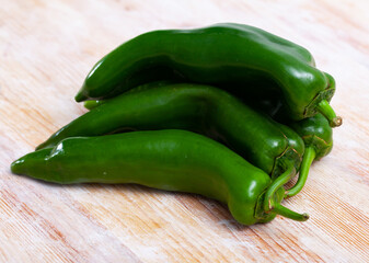 Whole and sliced fresh bell pepper on wooden table. Healthy vegetarian ingredient
