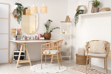 Interior of light dressing room with makeup table, lamps and plants