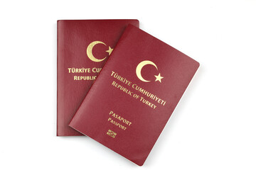 2 Turkish passports stacked on top of each other isolated on a white background
